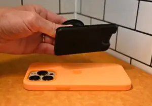 Popsockets wallet for magsafe magnetically sticking to an iPhone 13